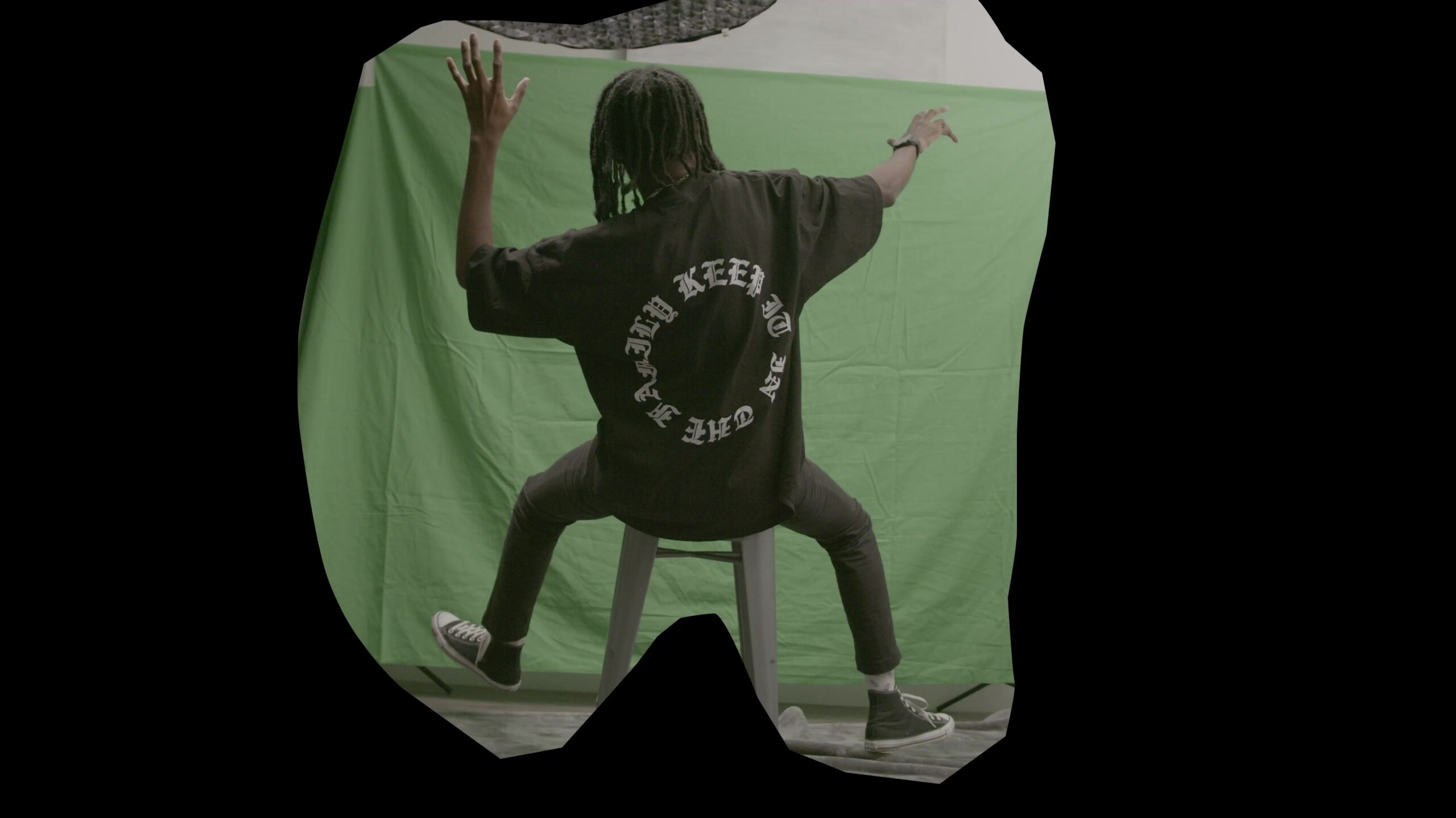 A rough outer boundary is already visible in this clip. It excludes much of the room, but the backdrop and stool remain inside it. This is a different stage from a finished subject matte.