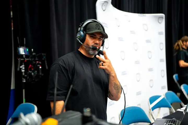 Jan-Michael Reyes wearing a cap and headset beside the production equipment
